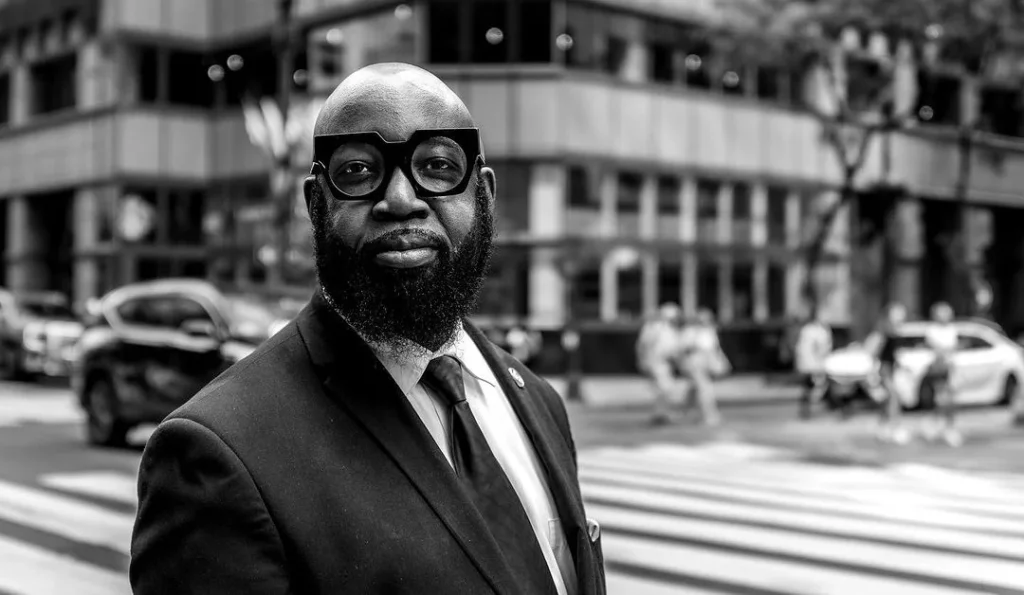 black and white photo of a man with weird glasses, urban street photography