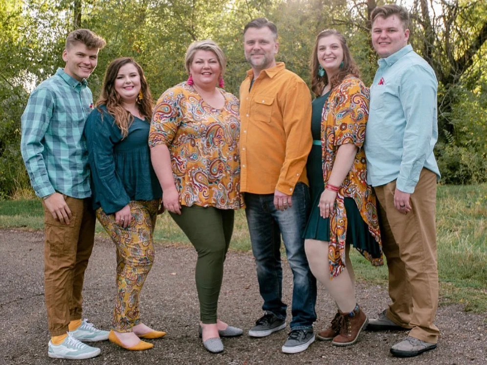 family posing for a family photoshoot, wearing their family photoshoot outfit