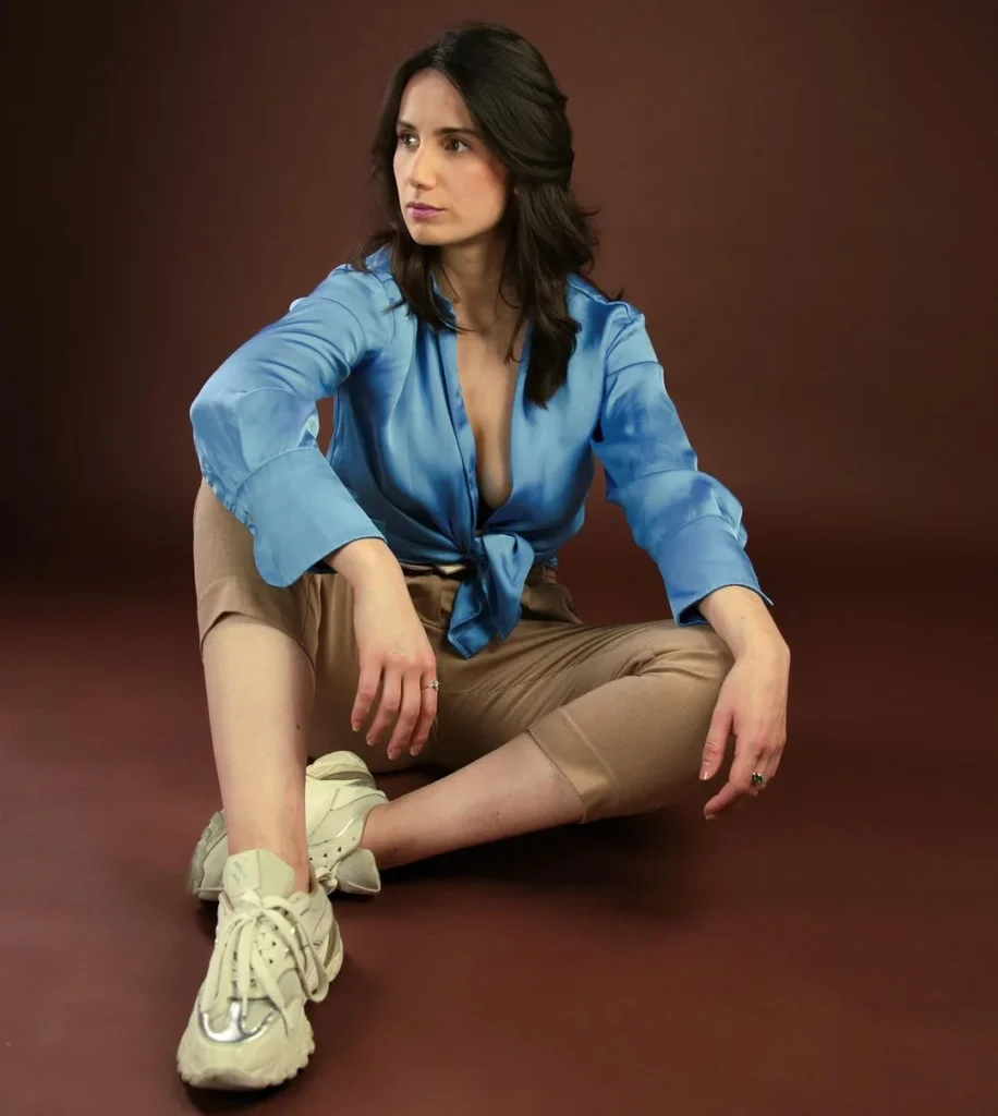woman looking away from the camera while sitting on the ground 