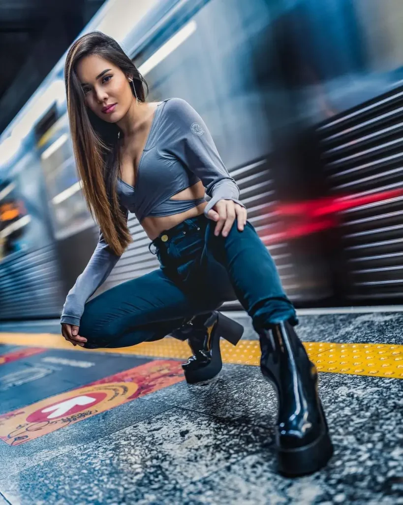 urban portrait photography of a girl posing in front of a moving train