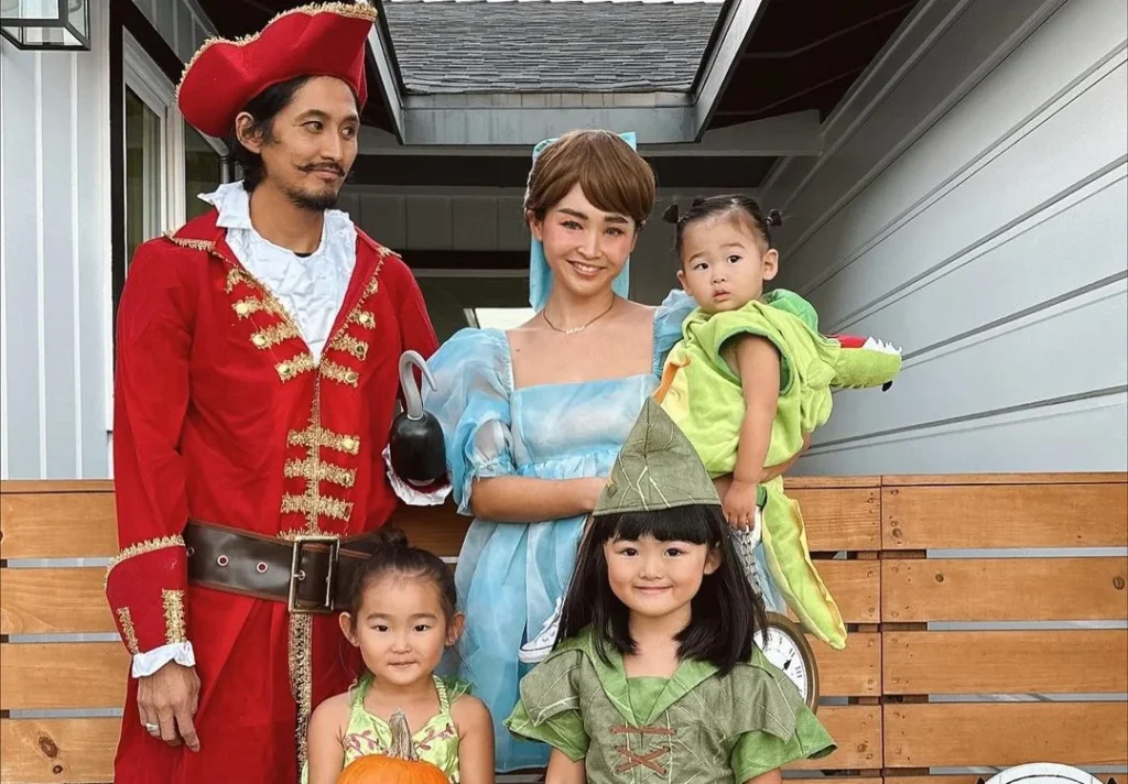 Cute asian family posing as pirates and faries for their halloween photoshooting