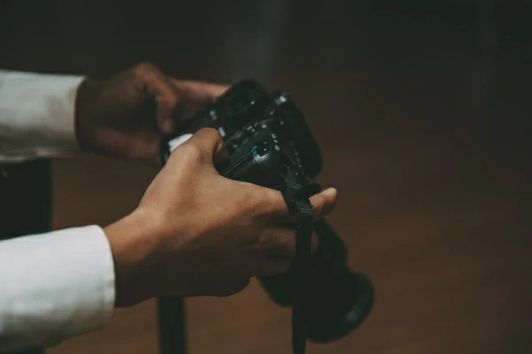 man holding a camera with both hands