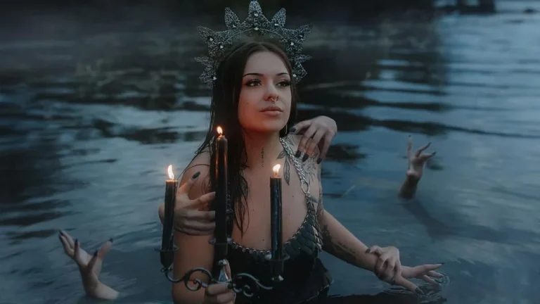 woman swimming in a lake with a candle, surrounded by spooky hands which stick out of the lake, posing for a halloween photoshoot