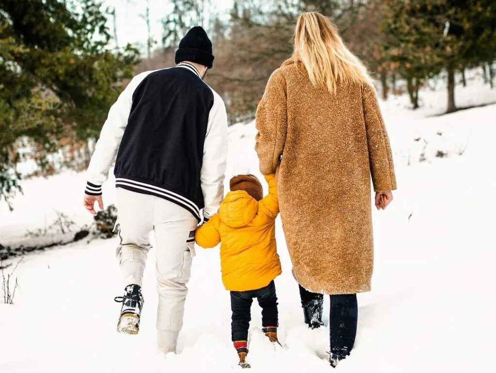 cute photo of family walking away while holding hands in a winter photography