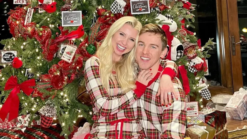 couple in matching pjs in front of their nice christmas tree, posing for cute couple christmas photos xmas