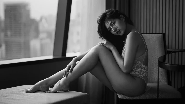 beautiful woman posing for boudoir photography, black and white photo, sitting sensual pose