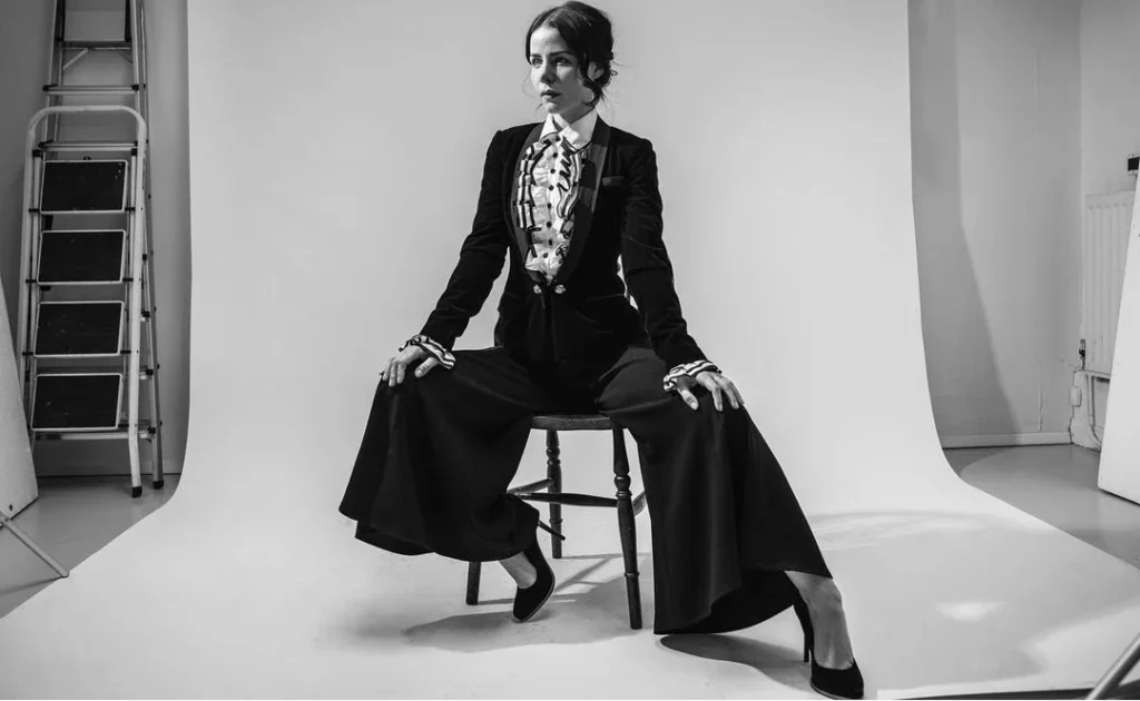 old fashioned gilr with high heels posing in black and white for a professional photoshoot in a studio, portrait photos with neutral background