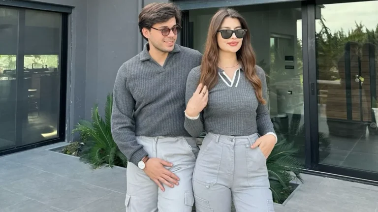 fashion couple with matching outfits posing for the camera, luxury house and outfits