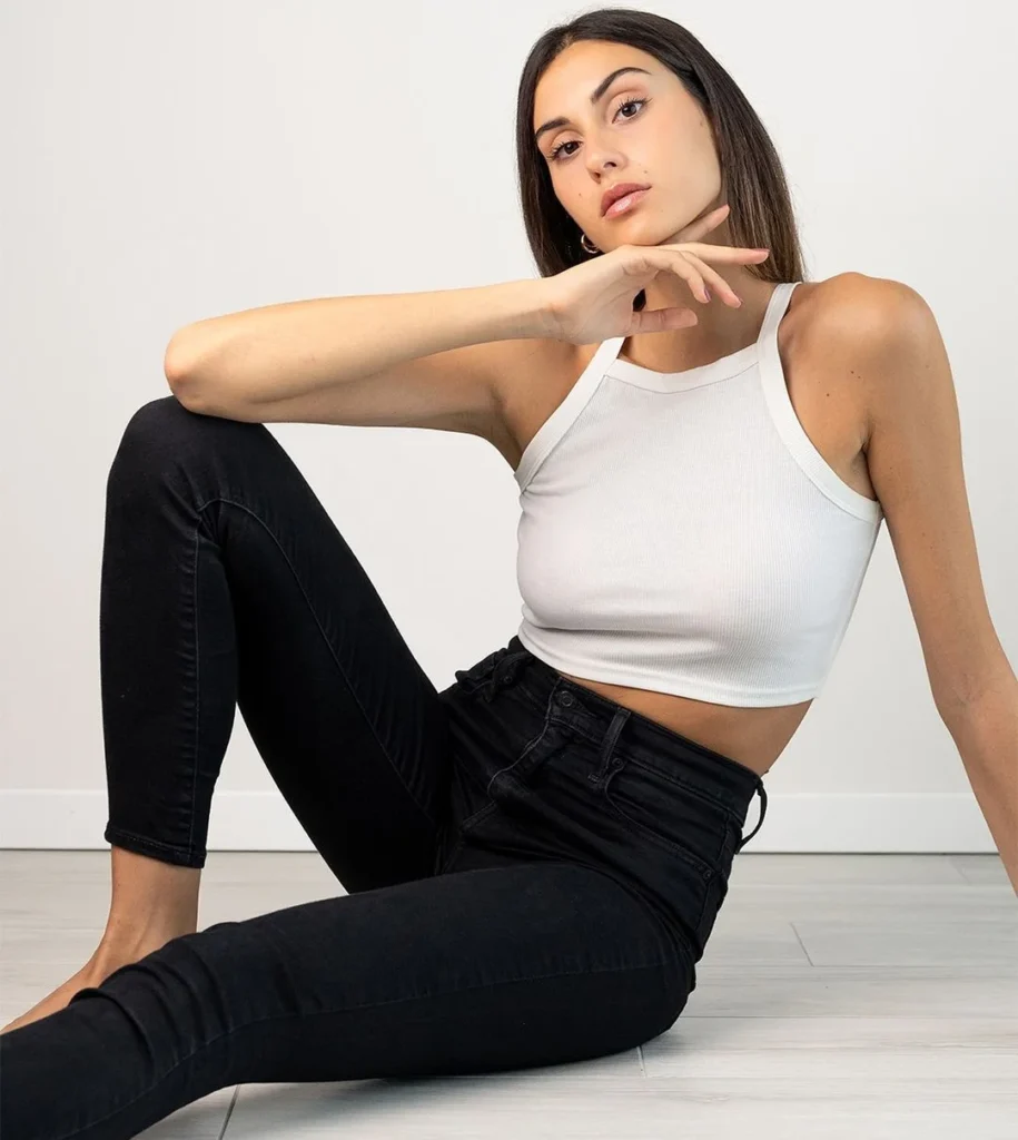 pretty girl with makeup posing for full body portrait photography with a white croptop and a strong attitude