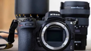 the best nikon camera for beginners in 2024, cool photo of a nikon camera with two lenses in the background for photographers