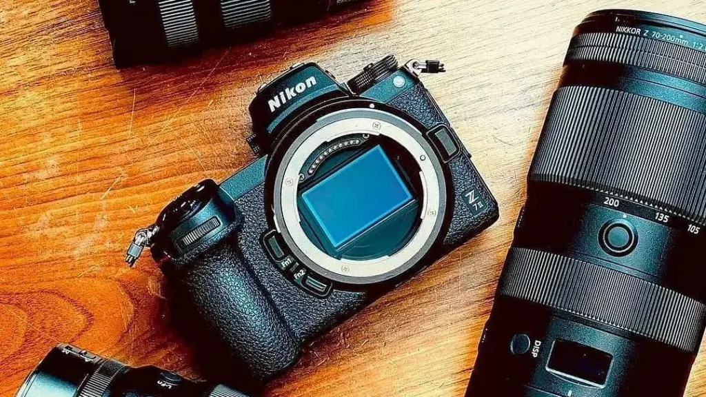 the best nikon cameras for beginners on a wooden table with lenses and objectives, nikon z7 II, full frame nikon dslr mirrorless camera
