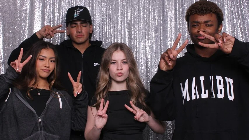 cool teenagers doing funny photo booth poses for their birthday, peace sign