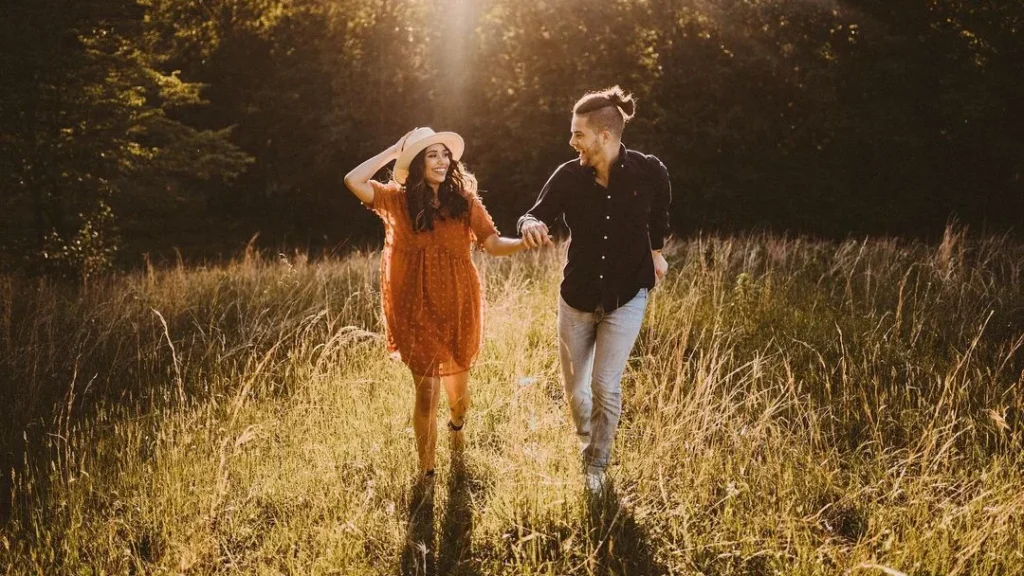 couple walking in the woods at golden hour, cute couple summer photoshoot ideas, summer outfit ideas